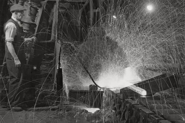 A steel foundry worker oversees the rolling and saw cutting of semi molten metal billets on 27th January 1942 at the Andrew & Company Toledo Steel Works, Neepsend Lane in Sheffield, England.  (Photo by Fox Photos/Hulton Archive/Getty Images).