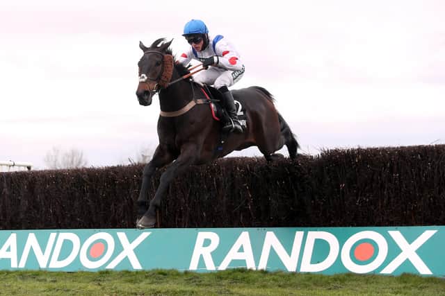 Harry Cobden and Clan Des Obeaux clear the last in the Betway Bowl on day one of the Randox Grand National meeting.