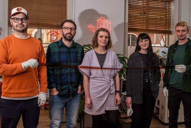 Staff from Take It Easy film lab in Leeds, posing for a group photo holding a 35mm colour film negative. From left to right: Nick, Liam, Louise, Sophie, Joe. Picture: Ernesto Rogata.