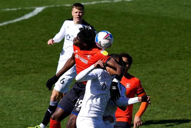 NIGHTMARE: Luton Town's Elijah Adebayo (left) and Barnsley's Toby Sibbick battle for the ball at Kenilworth Road on EAster Monday. Picture: John Walton/PA