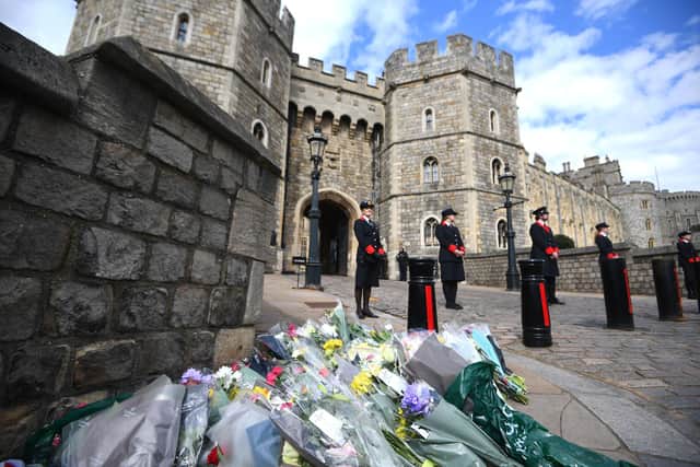 Floral tributes are left at Windsor Castle after the death of Prince Philip was announced.