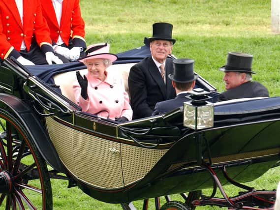 The Queen and Prince Phillip are pictured during the Royal Procession on the first day of Royal Ascot at York, in June 2005. The famous festival was held at York Racecourse while Ascot was refurbished (Picture: AFP via Getty Images).