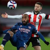 GOALSCORER: Alexandre Lacazette, shielding the ball from Oliver Norwood, put Arsenal in front