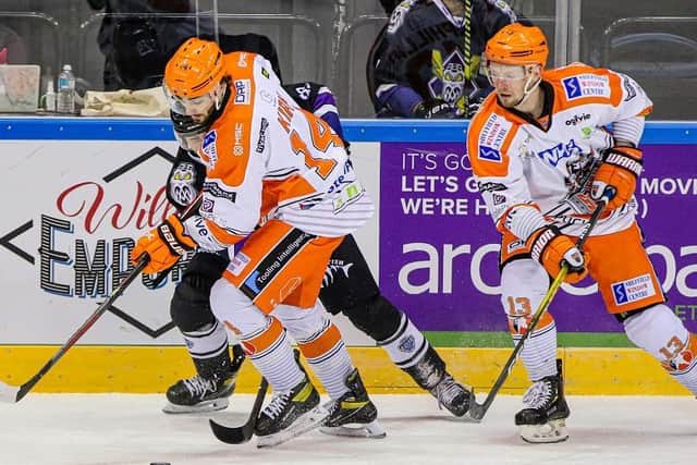 BATTLING: Liam Kirk, left and Davey Phillips, battle for the puck. Picture: Mark Ferriss/EIHL.