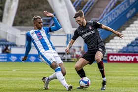 Huddersfield Town's Juninho Bacuna challenges Millers' Lewis Wing. Picture Tony Johnson