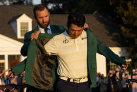 Perfect fit|: Hideki Matsuyama puts on the champion's green jacket with help from Dustin Johnson after winning the Masters. Picture: AP Photo/David J Phillip
