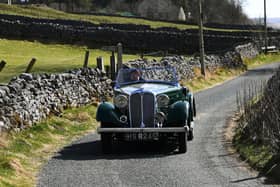 A vintage car is driven to an All Creatures Great and Small filming location near Kettlewell