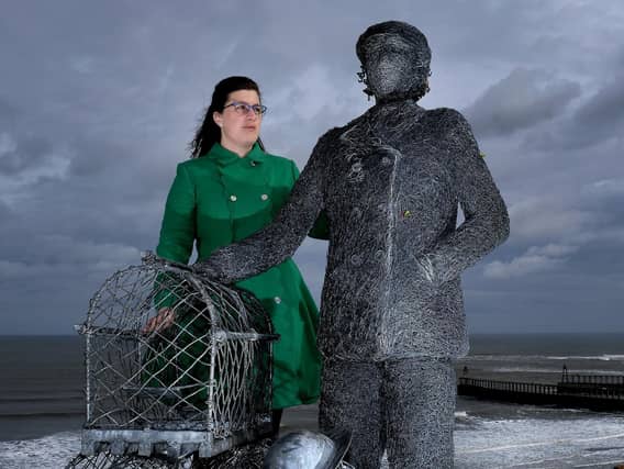 Zoe Taylor beside a statue from Emma Stothard to honour her great aunt Dora Walker. The Whitby Civic Society is now to dedicate a blue plaque to Whitby's first female skipper. Image by Richard Ponter.