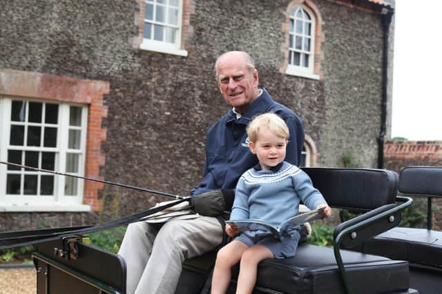 Prince Philip with a young Prince George. Photo: Duke and Duchess of Cambridge.
