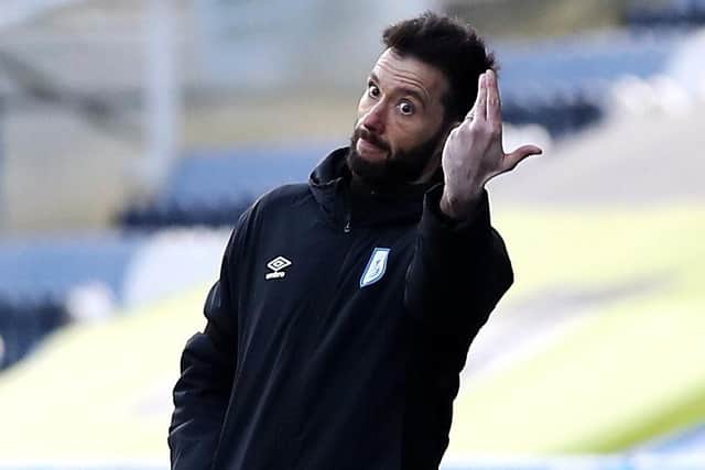 Huddersfield Town manager Carlos Corberan gestures on the touchline.