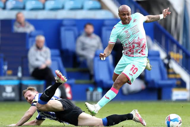 Andre Ayew of Swansea City evades a tackle by Tom Lees of Sheffield Wednesday. (Photo by George Wood/Getty Images)