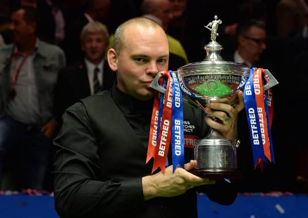 Stuart Bingham celebrates with the trophy after winning the 2015 Betfred World Championship. Picture: Anna Gowthorpe/PA Wire