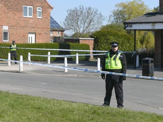 Police guard a cordon in Stanks Parade, Swarcliffe.