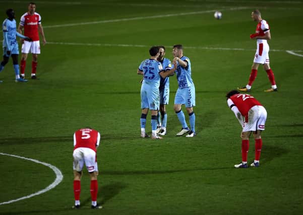 Coventry City's Matty James, Liam Kelly and Kyle McFadzean (left-right) celebrate after the final whistle as the Rotherham United players appear dejected. Photo: Tim Goode/PA Wire.