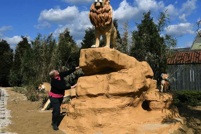 Anna Kenworthy checking on the lion sculpture