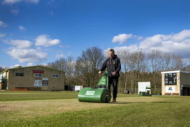 Ready to resume: Groundsman James Nixon prepares the pitch at Woodlands.