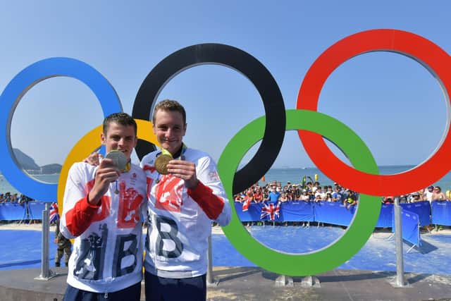 Games glory: Britain's Alistair Brownlee, right, and brother Jonny with their medals next to the Olympic rings after the men's triathlon at Fort Copacabana during the Rio 2016 Olympic Games.