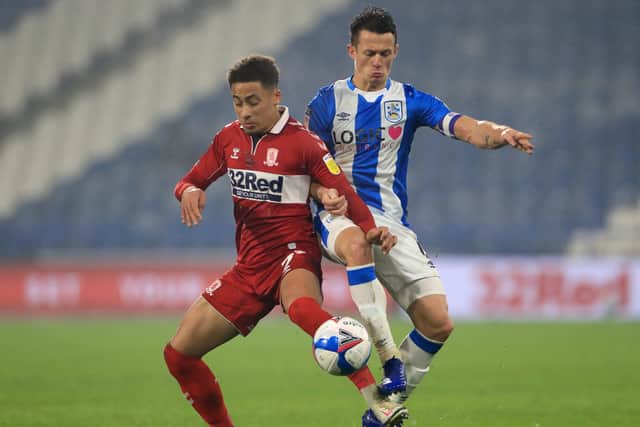 Middlesbrough's Marcus Tavernier (left) and Huddersfield Town's Jonathan Hogg battle for the ball.