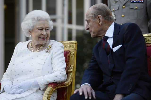 Queen Elizabeth II and the Duke of Edinburgh at a garden party in Paris