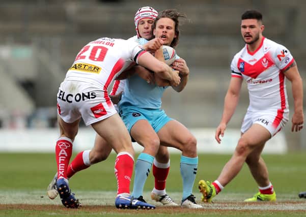 Wakefield Trinity's Jacob Miller  is tackled by St Helens. Picture: PA