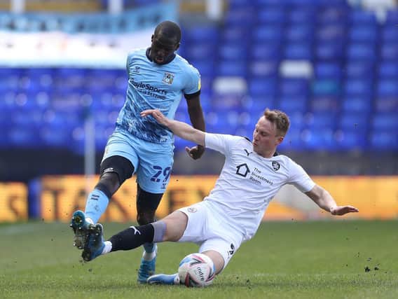 Barnsley top-scorer Cauley Woodrow challenges Coventry's Julien Dacosta. Picture: PA.