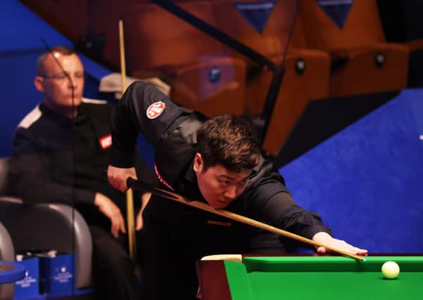 Yan Bingtao plays a shot during the Betfred World Snooker Championship in front of a limited crowd at the Crucible. Pictures: PA