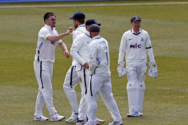 Yorkshire's Jordan Thompson (L) celebrates after taking the wicket of Jack Leaning.