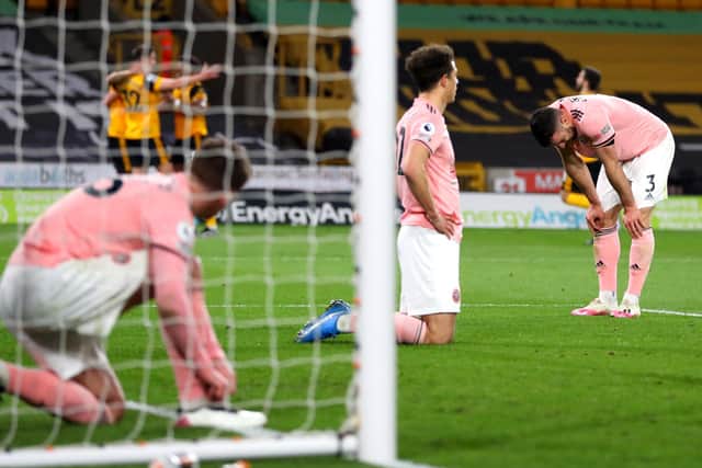Sheffield United's Enda Stevens (right) looks dejected after Sheffield United concede the goal that sealed their fate (Picture: PA)
