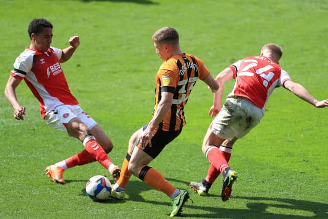 Hull City's Greg Docherty battles for the ball with Fleetwood Town's James Hill (left) and Daniel Batty (right) during the Sky Bet League One match at the KCOM Stadium, Hull. (Picture: PA)