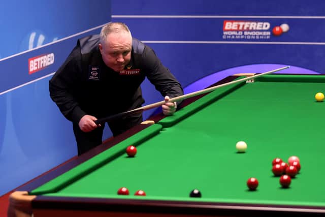 John Higgins contemplates his next shot during his match against Tian Pengfei at The Crucible. Picture: George Wood/PA