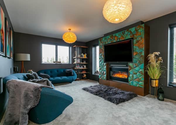 Overlooking Farnham boating lake, this contemporary family home has an on-trend colour scheme throughout, with a feature wall fireplace in the living room, five bedrooms and a home office. Contact: myringsestateagents.com