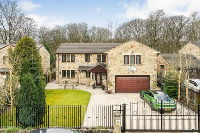 The Dell: Imposing modern, stone built six-bedroom detached family home in Fixby, standing securely behind electric gates. Woodland view at the back, £795,000. Contact: simonblyth.co.uk