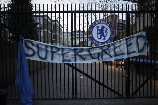 A banner hangs from one of the gates of Stamford Bridge stadium in London where Chelsea fans were protesting against Chelsea's decision to be included amongst the clubs attempting to form a new European Super League. (AP Photo/Matt Dunham)