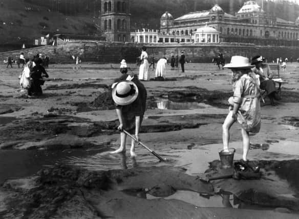 1913:  Bathers playing on the sands at Scarborough, a popular coastal resort in North Yorkshire.  (Photo by Hulton Archive/Getty Images)