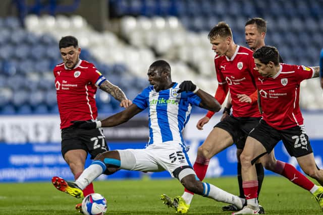 Huddersfield Town's Yaya Soinogo battles with Barnsley's Alex Mowatt,  Mads Andersen and Dominik Frieser. (Picture: Tony Johnson)