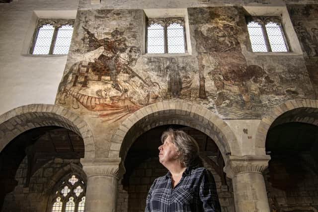 Churchwarden Pamela Robb at St Peter's and St Paul's Parish Church in Pickering where medieval frescoes adorn the walls dating from 1450 but were painted over during the reformation in the 16th century. Picture Tony Johnson