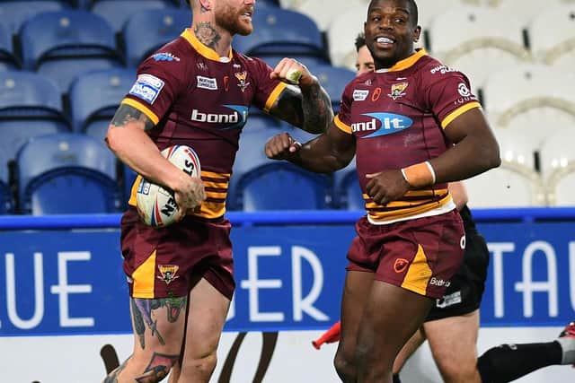 Huddersfield Giants' Chris McQueen, left, celebrates his try with Jermaine McGillvary. (JONATHAN GAWTHORPE)