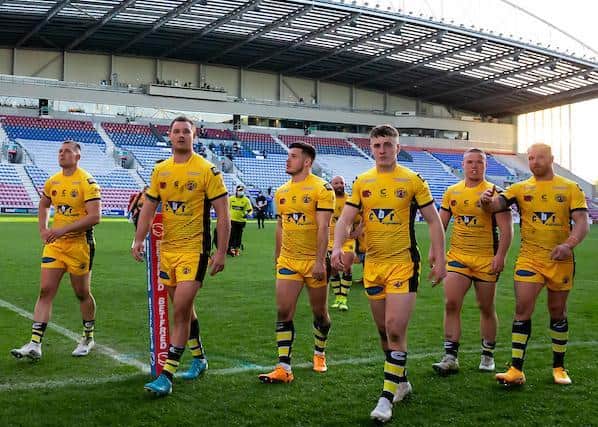 Dejected Tigers players leave the field after their loss to Wigan. Picture by Alex Whitehead/SWpix.com.