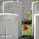 A rose growing between the headstones at the Commonwealth War Graves Commission's Wytschaete Military Cemetery, near Ypres, Belgium. Picture: Joe Giddens/PA Wire