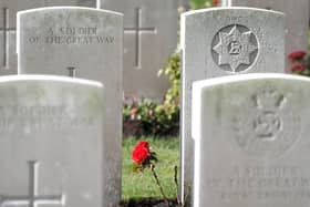 A rose growing between the headstones at the Commonwealth War Graves Commission's Wytschaete Military Cemetery, near Ypres, Belgium. Picture: Joe Giddens/PA Wire