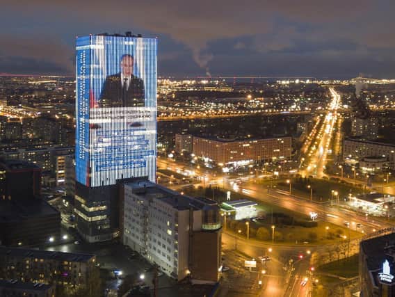An electronic screen, installed on the facade of a business tower, shows an image of Russian President Vladimir Putin speaking during his annual state of the nation address and a quote from his address in St. Petersburg, Russia, Wednesday, April 21, 2021. (Picture: AP/Getty)