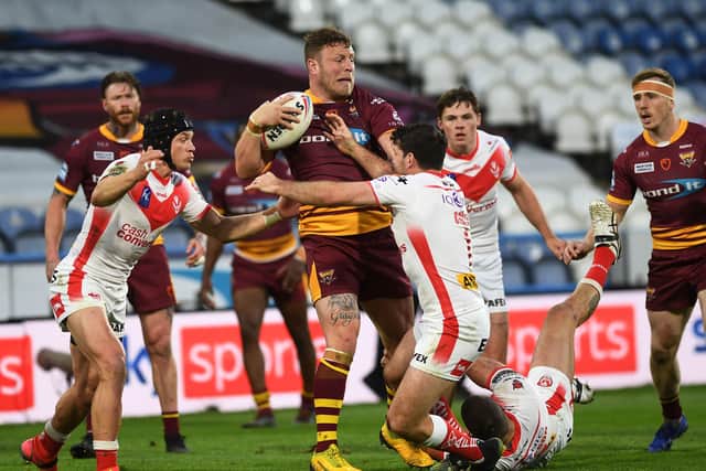 Giants' Josh Jones is tackled by St Helens's Lachlan Coote on Thursday night.  Picture: Jonathan Gawthorpe