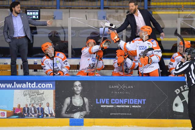 Aaron Fox catches a stray puck on the Sheffield Steelers' bench. Picture: Dean Woolley.