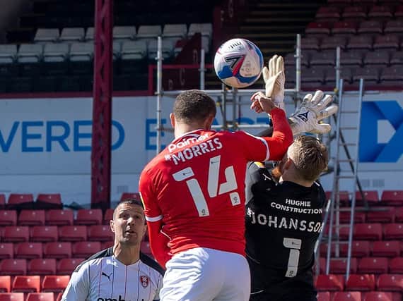 Barnsley's Carlton Morris challenges Rotherham United keeper Viktor Johansson for the hosts' controversial early opener at Oakwell. PICTURE: BRUCE ROLLINSON.
