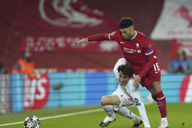 ANOTHER WORLD: Real Madrid's Alvaro Odriozola, left, is challenged by Liverpool's Alex Oxlade-Chamberlain during a Champions League quarter final second leg match at Anfield last week. Picture: AP/Jon Super.