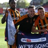 Going up: Hull City's Malik Wilks, James Scott and Greg Docherty celebrate promotion. Pictures: PA
