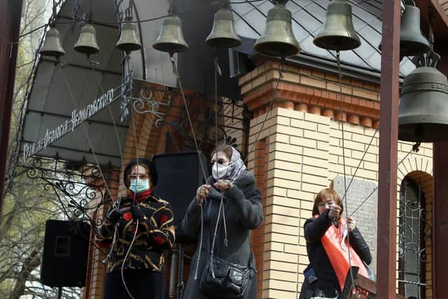Today marks 35 years since the Chernobyl nuclear disaster. Pictured are women wearing face masks to protect against coronavirus ringing the church bells at a memorial of the Chernobyl tragedy victims in capital Kiev, Ukraine, last year. A reactor at the Chernobyl nuclear power plant exploded on April 26, 1986, leading to an explosion and the subsequent fire spewed a radioactive plume over much of northern Europe. Photo credit: AP Photo/Efrem Lukatsky.