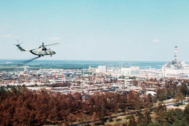 A military helicopter is pictured spreading stuff supposed to reduce the contamination of the air full of radioactive elements above the Chernobyl nuclear plant, a few days after its No. 4 reactor's blast, the world's worst nuclear accident of the 20th century. Photo credit: STF/AFP/Getty Images