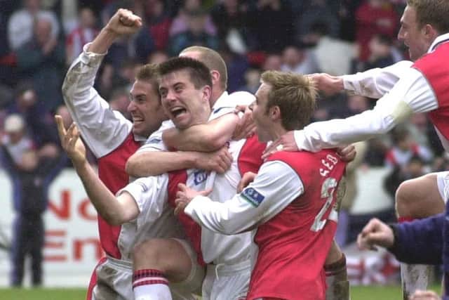 Rotherham United's Alan Lee is mobbed by team mates after he scored the last minute winner.