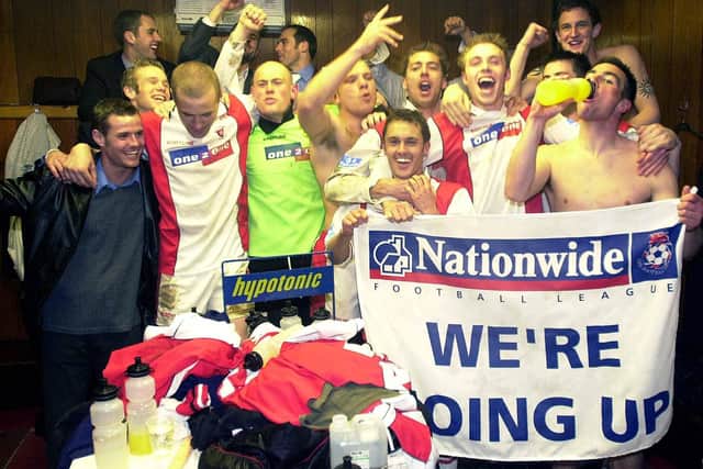 The joyous Rotherham team celebrate promotion after beating Brentford.